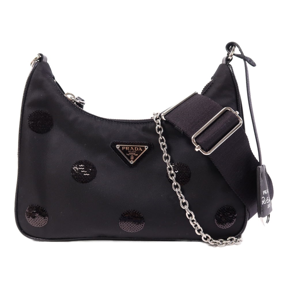 Prada Sequin Polka Dot Black: Black nylon and sequin Prada chain 2-way shoulder bag with storage bags, shoulder strap, clochette, and pouch. Approx. 22 x 16 x 4.5 cm; strap 77-111 cm. Authentic and authenticated.