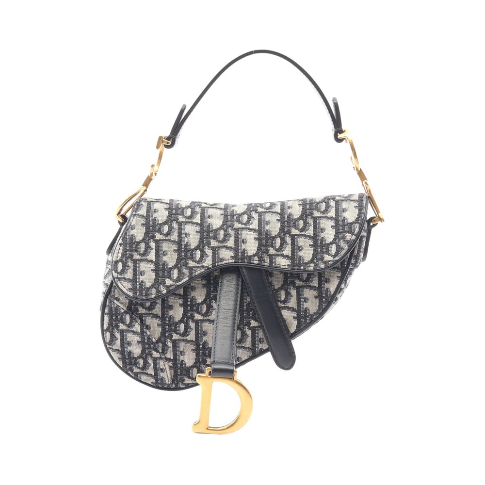 Dior Mini Saddle Handbag: Ivory and navy Oblique jacquard canvas and leather mini saddle handbag; H13 x W19 x D6 cm; handle 34 cm. Authentic and authenticated.