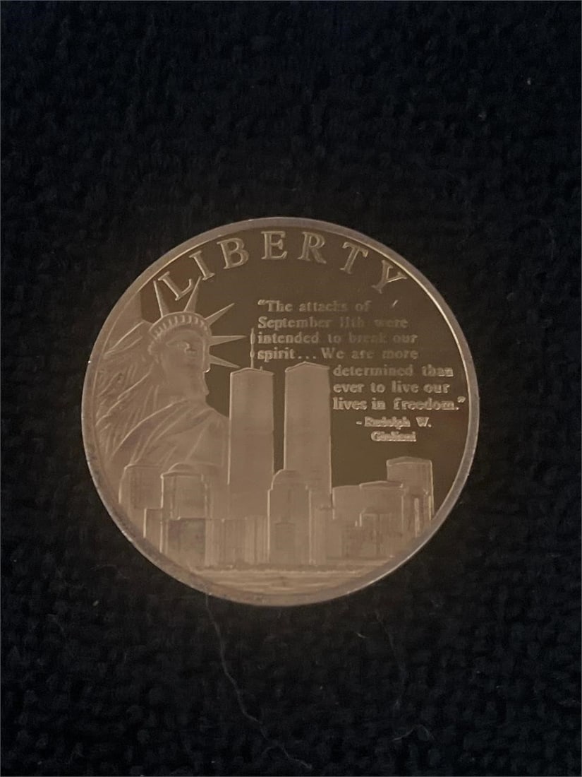 Liberty Remembering 9/11 Commemorative Coin: This commemorative coin was issued in 2011 as part of a limited release of 9,999 complete collections. Struck in copper layered with 24k gold, the coin weighs 32 grams and measures 40 millimeters in d