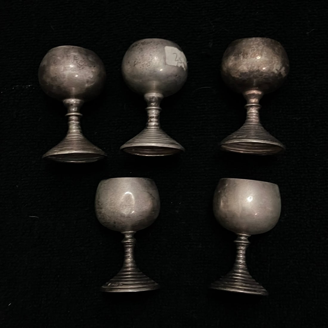 800 Silver Mini Goblets 94.0 g: Set of five small stemmed drinking cups in silver-toned metal, each with a rounded bowl and stepped circular foot. Underside marks appear to include an 800 silver fineness mark, with additional maker
