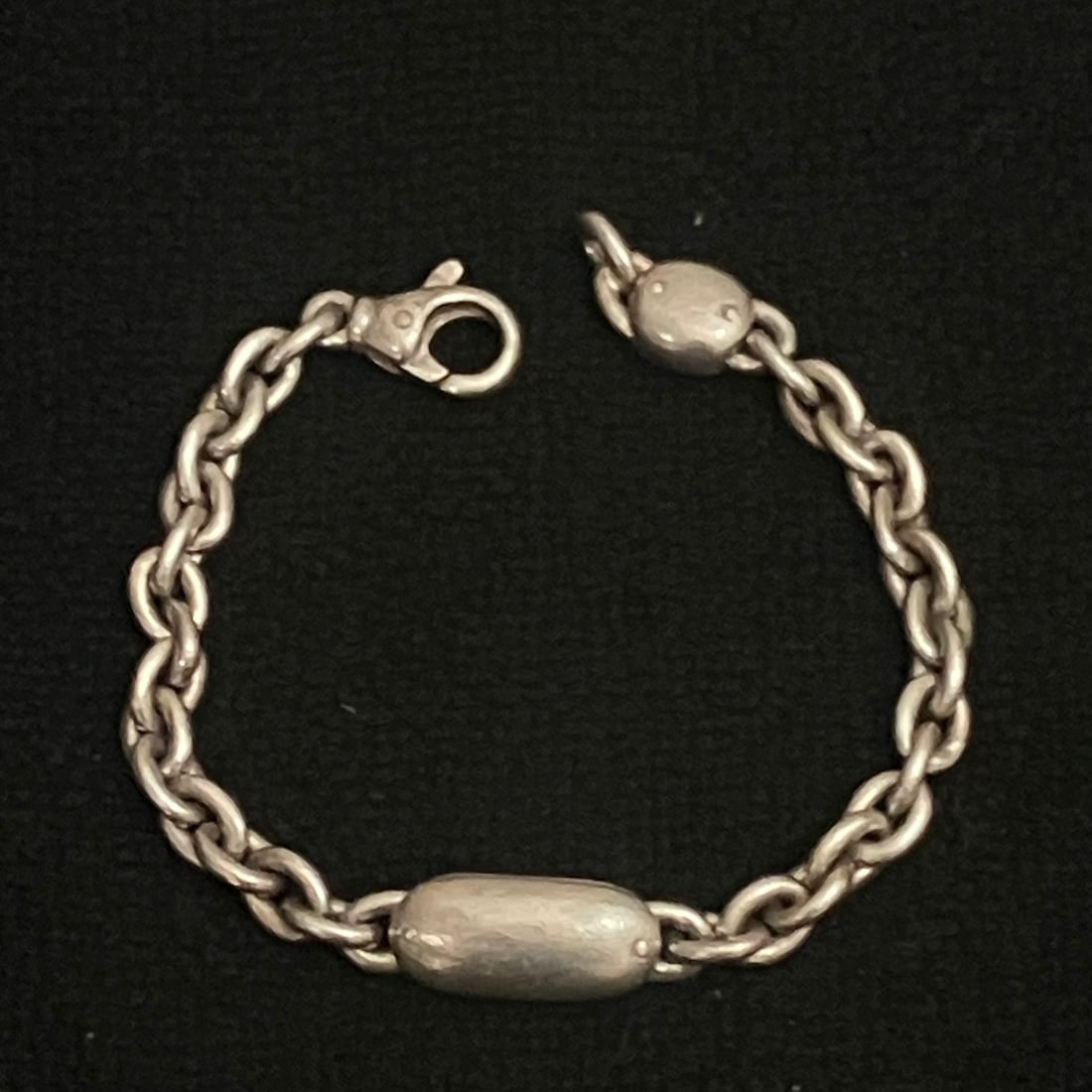 Sterling Silver Chain Link Bracelet 39.2 g: Heavy link bracelet in silver-tone metal with lobster clasp closure and two elongated station elements. A 925 hallmark is visible near the clasp, supporting sterling silver identification.