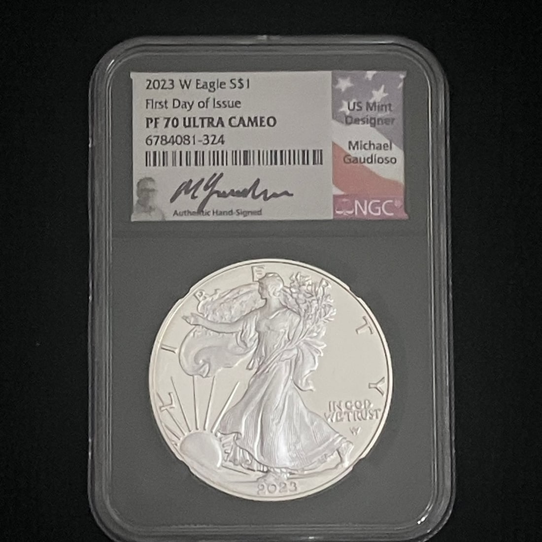 2023-W Silver Eagle Proof NGC PF70: Graded 2023-W American Silver Eagle proof dollar encapsulated in an NGC holder. Label shows PF 70 Ultra Cameo, First Day of Issue, certification number 6784081-324, and a Michael Gaudioso