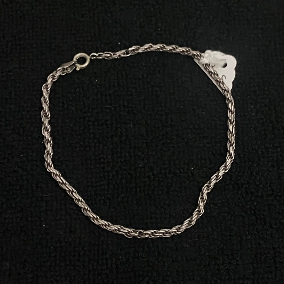 925 Italy - Sterling Silver Braided Bracelet 8.3 g: Silver-tone chain bracelet with braided/twisted link construction and spring ring clasp. Marked "925" and "ITALY" near the clasp. Approximate length appears to be 7.25 inches, with a shown weight of