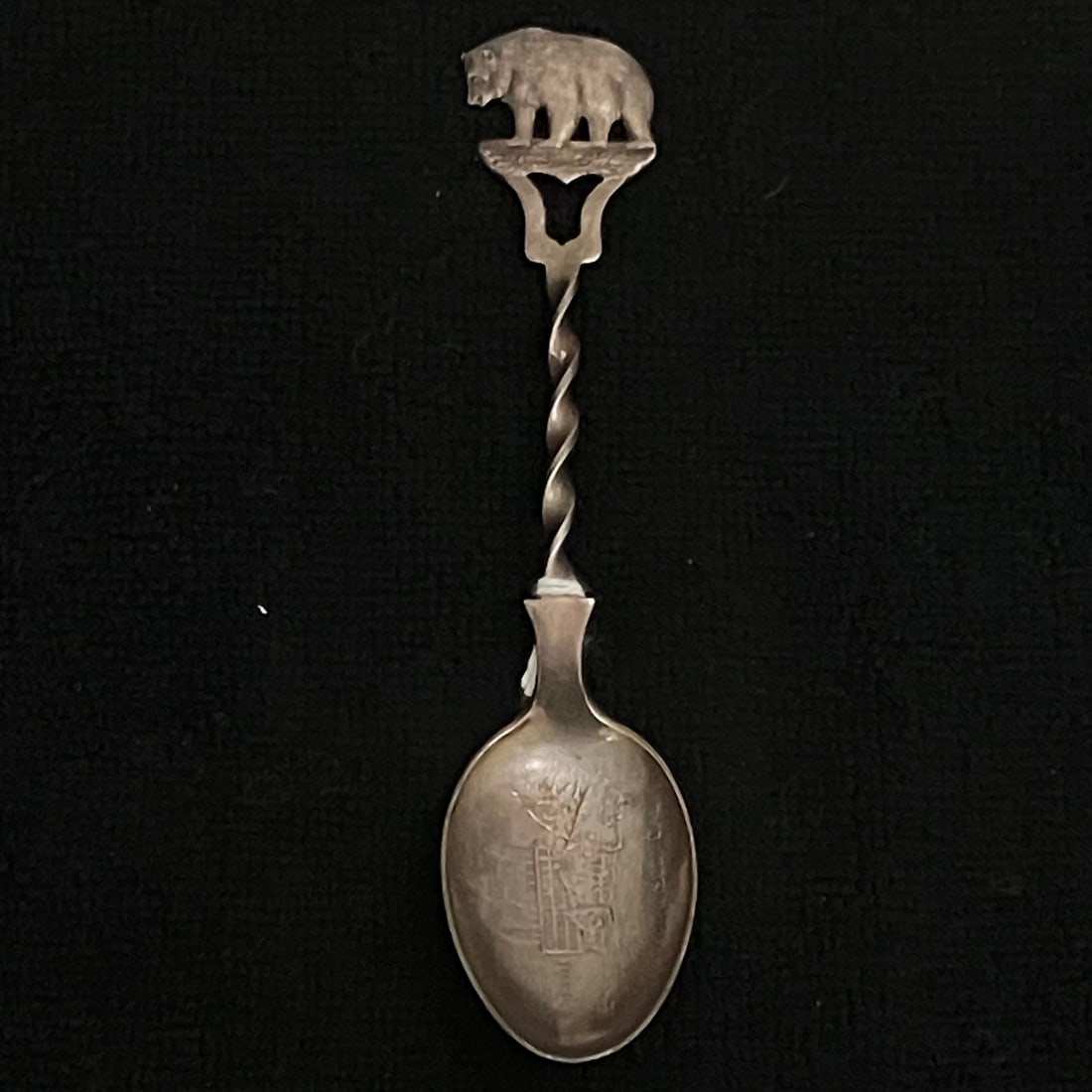 Sterling Silver Bear Souvenir Spoon 19.6 g: Sterling silver souvenir spoon with a cast bear finial, twisted stem, and an engraved bowl showing a tramway/streetcar scene with partially legible wording. Reverse is stamped STERLING. Maker not