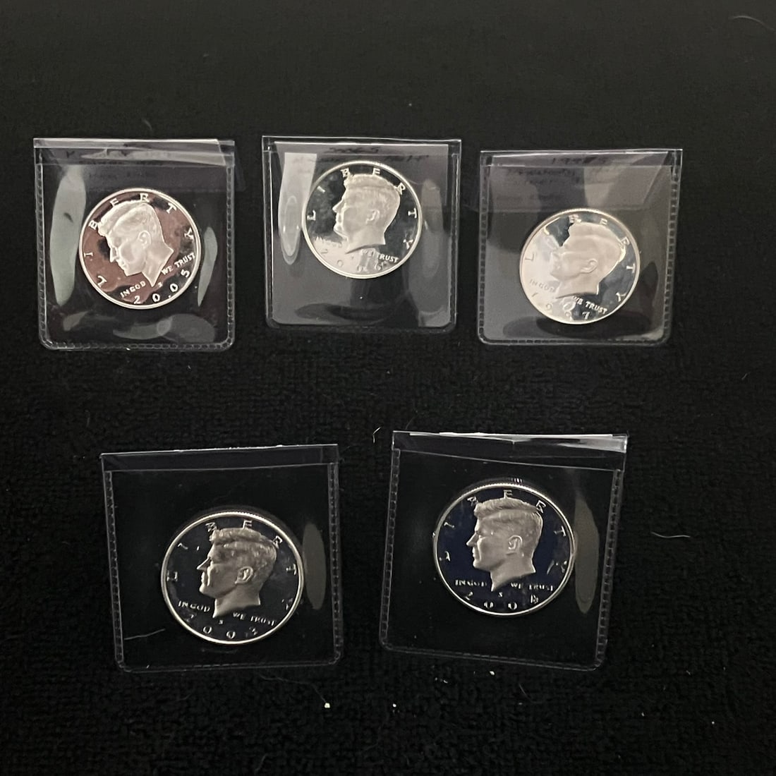 5 - Kennedy .90 Silver Half Dollar Cameo Proof: Lot of five Kennedy half dollar proof coins in individual plastic holders. Visible dates include 2003-S, 2004-S, 2005-S, 2006-S and 2007-S, and visible obverse mint marks appear to be “S.”