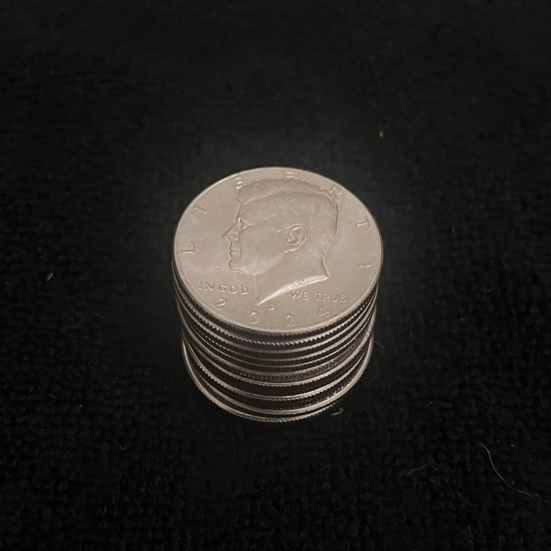 13 Kennedy Half Dollars: Group lot of 13 United States Kennedy half dollar coins. Photos show mixed obverse and reverse views with the Kennedy portrait and heraldic eagle reverse. Coins appear circulated with visible surface