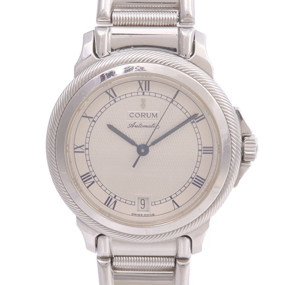 Corum Temps Mechanique Auto SS Beige: Automatic watch in stainless steel, beige color. Accessories: none. Case diameter 36mm; max arm circumference 14cm; band width 15-16mm.