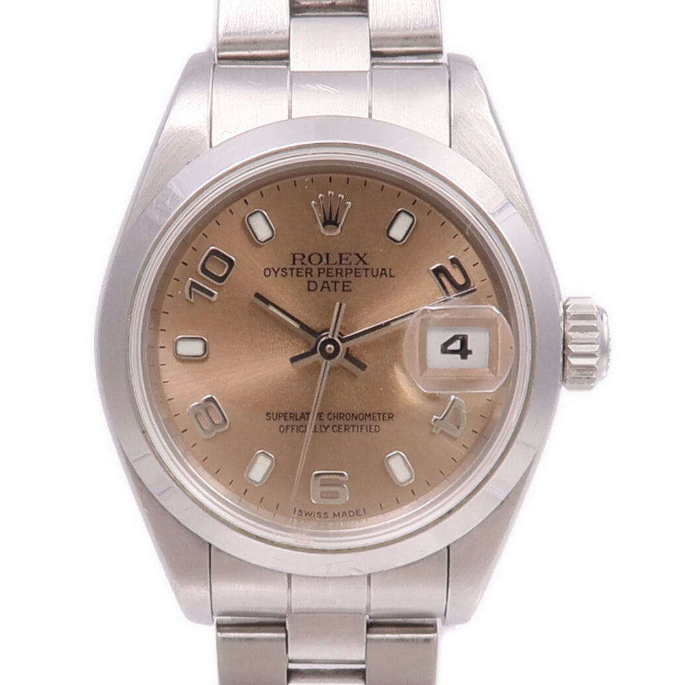 Rolex Oyster Perpetual Date Auto SS Bronze: Automatic watch in stainless steel, other / bronze color. Accessories: storage box, guarantee, case. Case diameter 26mm; max arm circumference 16cm; band width 10-12mm.