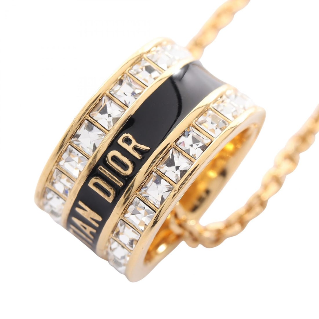 Dior Night Code Gold Necklace: Dior Night Code necklace in gold plated metal with rhinestone. Adjustable neck size 46-50cm. Motif 17mm wide x 17mm high.