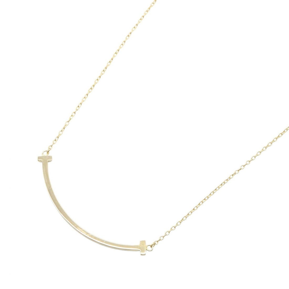 Tiffany T Smile Small Necklace K18: Color: Gold; Material: K18 (Yellow Gold); Neck: 44.5/49.5cm; Motif: 37mm x 3mm; Weight: 3g.