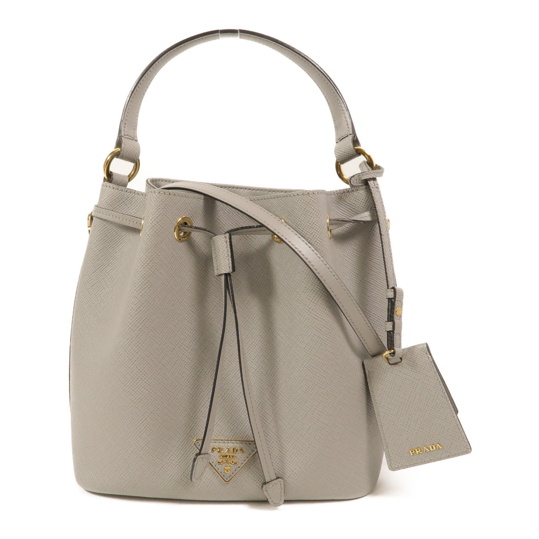 Prada GHW Bucket Bag Grey: GHW Bucket Bag 2 way shoulder bag in grey calfskin. Size: W22 x H23 x D13 cm. Handle 30 cm. Shoulder 111-121 cm. Includes guarantee, shoulder strap, and name tag.