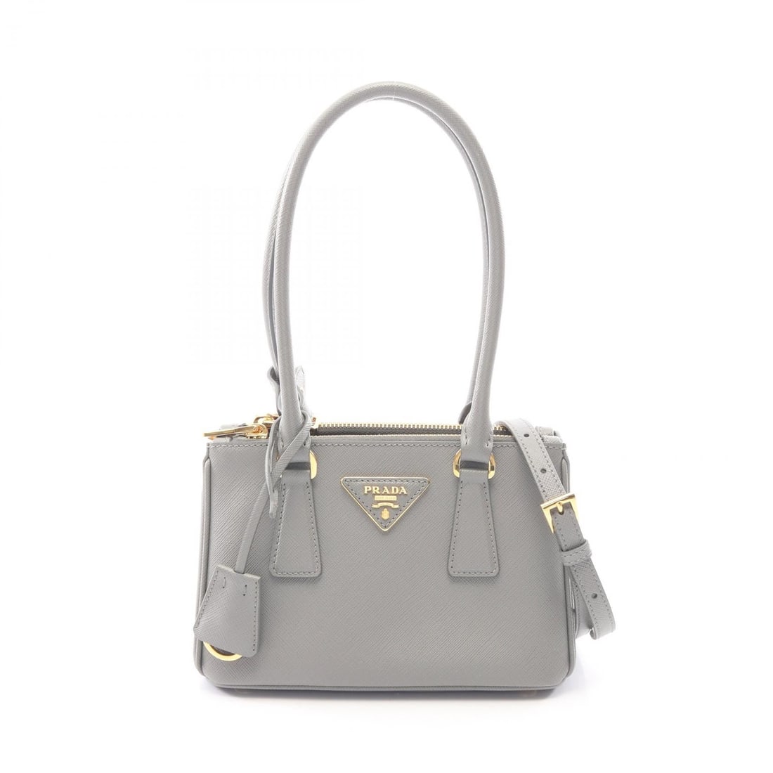 Prada Galleria Saffiano Lux Gray: Gray Galleria SAFFIANO LUX 2WAY handbag in Saffiano leather. Includes shoulder strap and poignet. 20 x 14 x 10 cm. Handle 46 cm. Shoulder 117-127 cm.