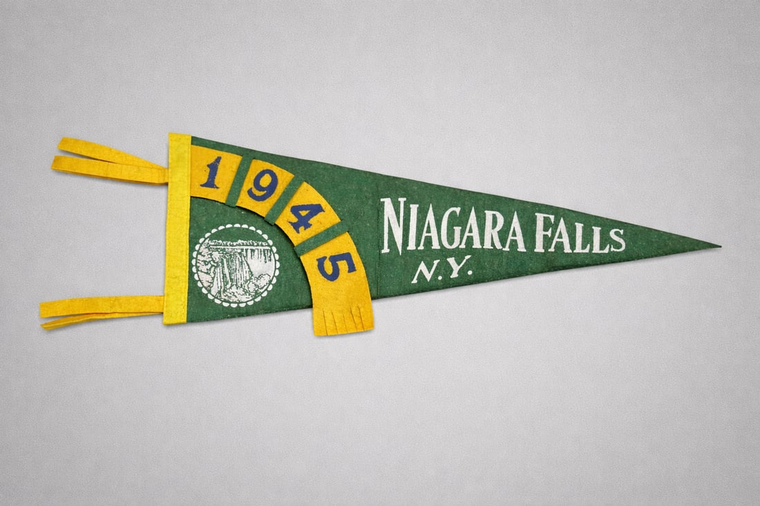 Vintage 1945 Niagara Falls NY Felt Pennant: Vintage felt souvenir pennant from Niagara Falls, New York, dated 1945. Classic green felt with yellow and blue applied felt numerals and white screened Niagara Falls emblem. Features original tassels