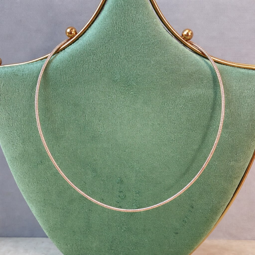 Sterling Silver Gold Vermeil Snake Collar Necklace: Sterling silver necklace with gold vermeil finish in a classic snake chain style. The chain has a smooth, flexible construction with a rich gold tone and subtle shine. Finished with a lobster clasp an