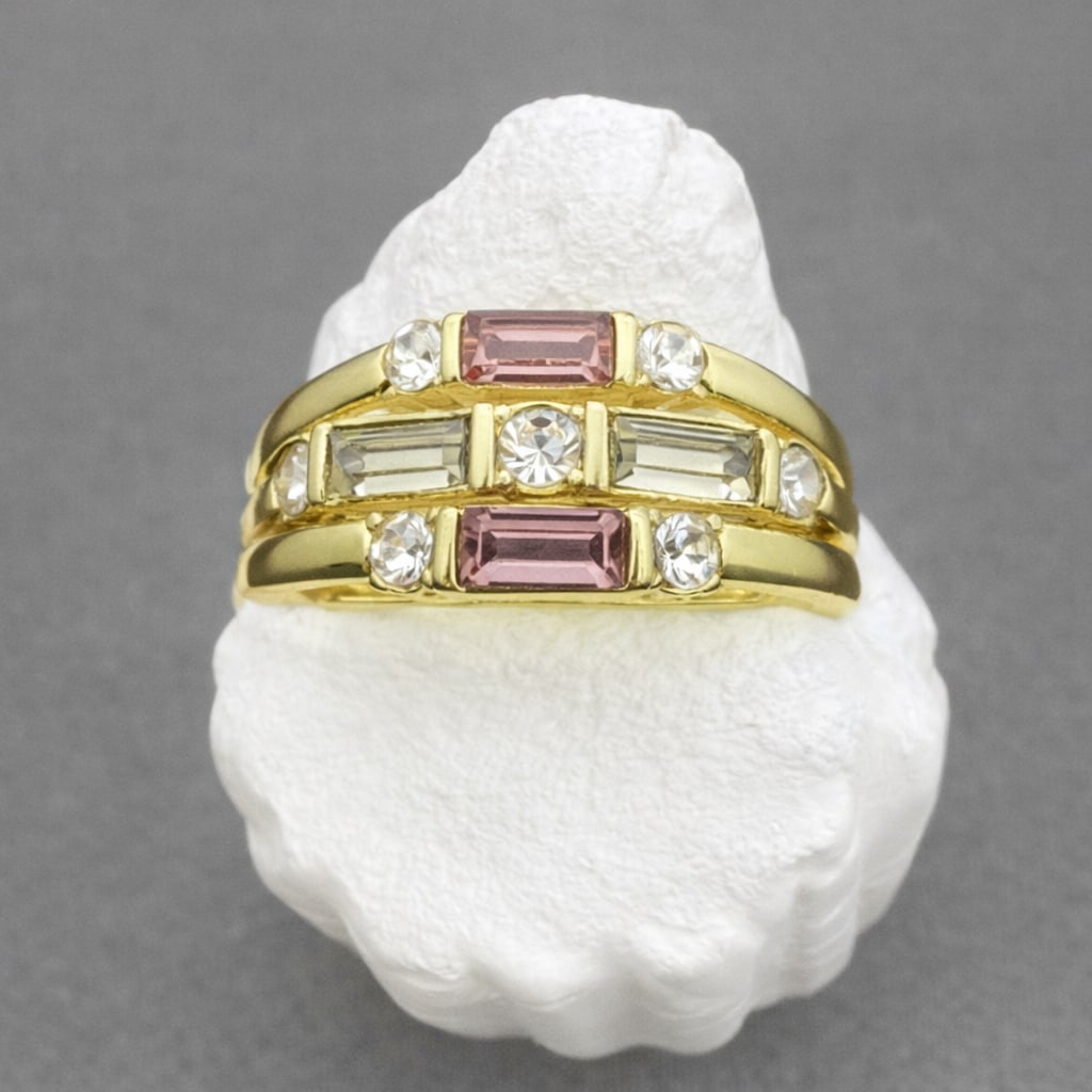 Gold Tone CZ Multi Stone Ring Size 9.25: Gold tone fashion ring set with multiple clear and pink cubic zirconia stones in a geometric stepped design. Features baguette-cut and round stones with two pink rectangular accent stones. Bright yell
