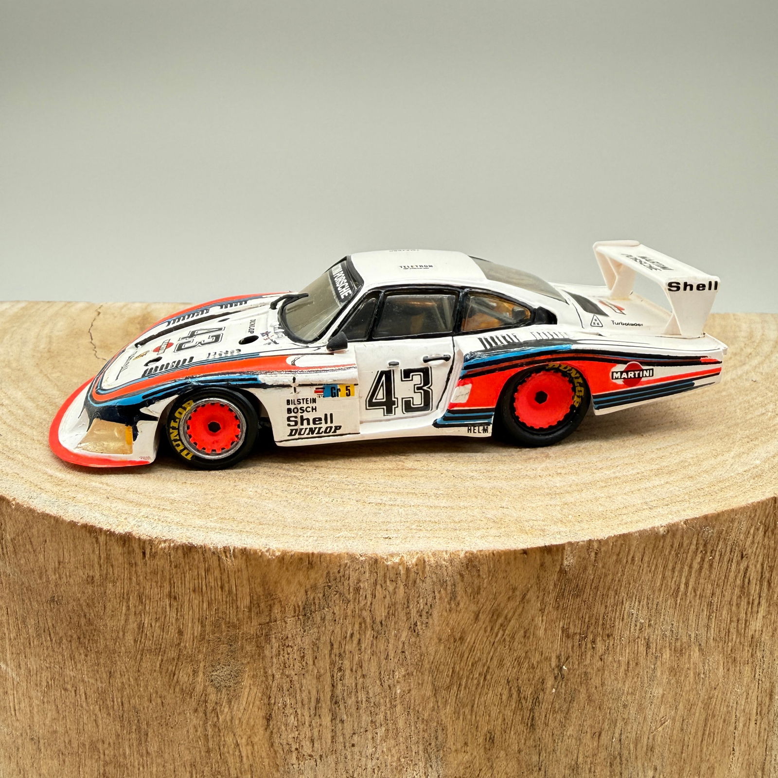 Record Resin 1:43 Porsche 935 Martini #43: 1:43 scale resin model of the iconic Porsche AG 935, finished in classic Martini racing livery and marked car #43. Good vintage display condition. Shows scattered paint wear, edge rubs, and small hand