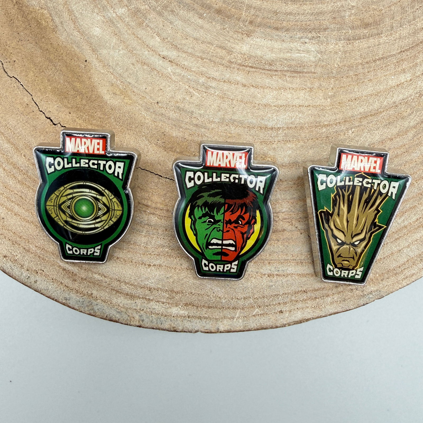Funko Marvel Collector Corps Enamel Pin Trio: Lot of three officially licensed enamel lapel pins from Marvel Collector Corps, produced by Funko. Includes character designs featuring Hulk, Groot, and the Eye of Agamotto associated with Doctor Stra