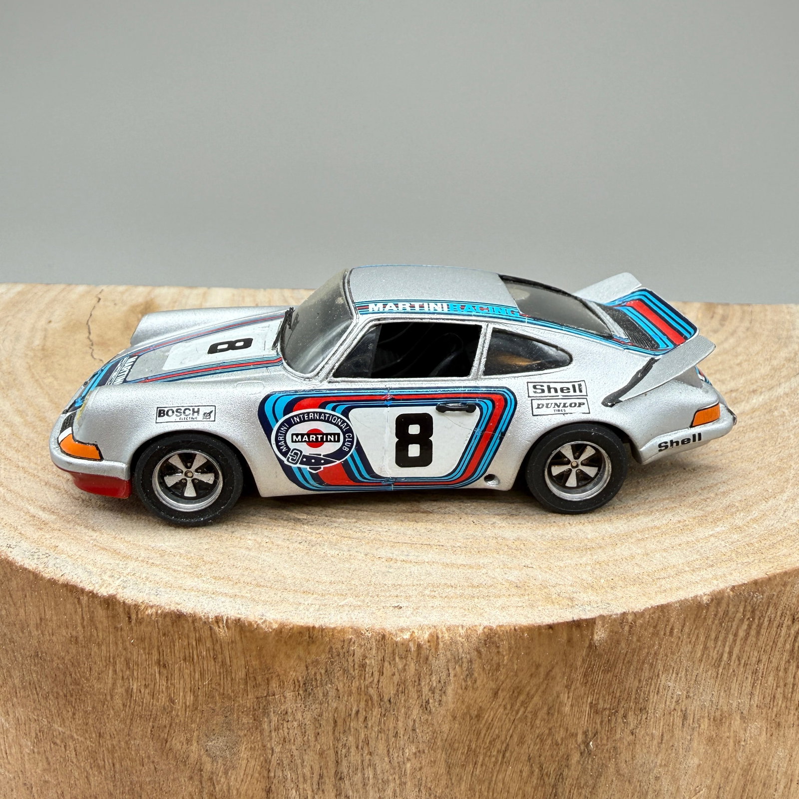 Starter Porsche 911 Martini #8 1:43 Model: 1:43 scale Porsche 911 racing model in Martini Racing livery, numbered 8. Resin body with detailed racing graphics including Martini, Bosch, Shell, and Dunlop sponsor markings.Base marked “Porsche 9