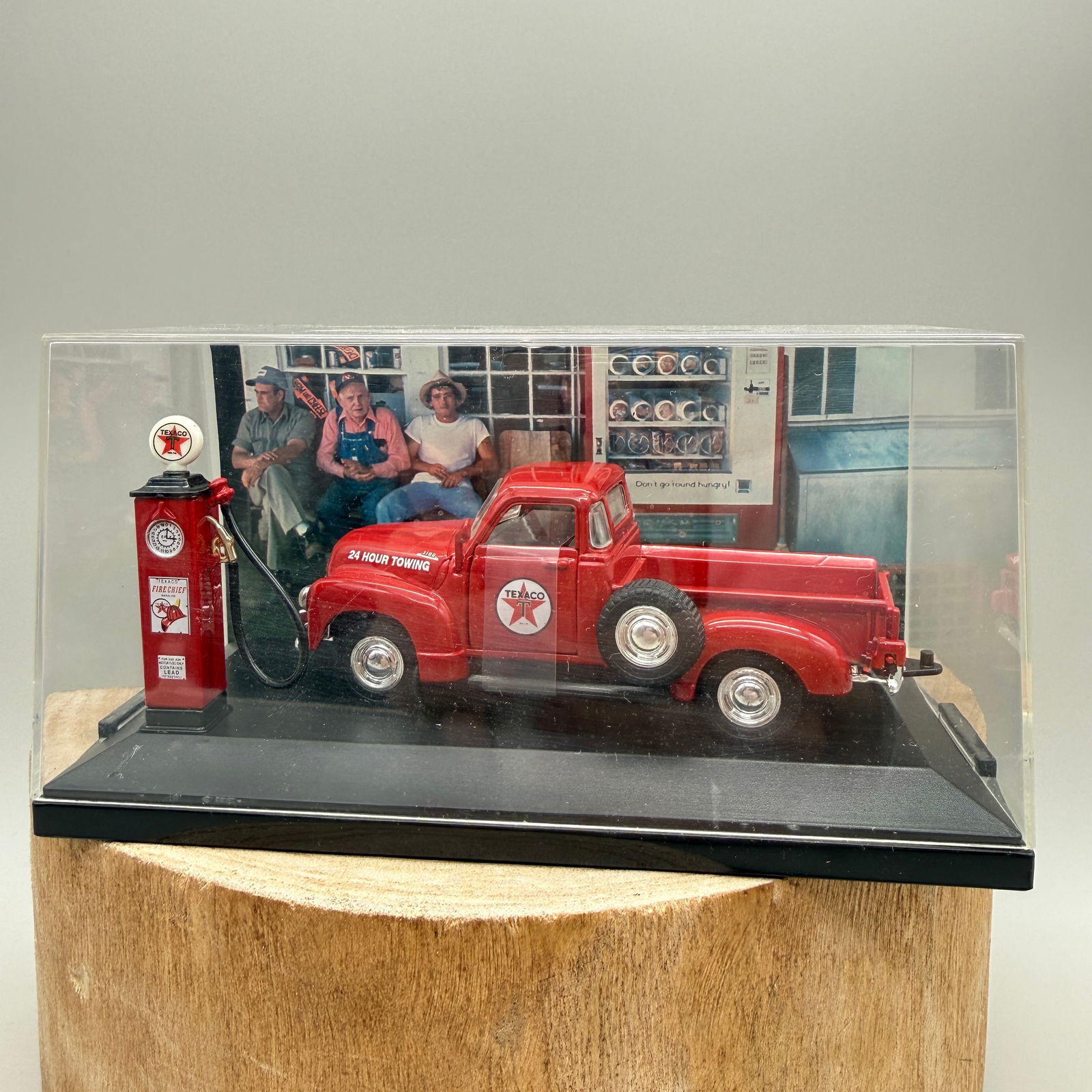 Texaco Gas Pump Diorama w/ Chevy Tow Truck: Diecast collector display featuring a Texaco service station scene with a red Chevrolet pickup tow truck and Texaco Fire Chief gas pump. The model is mounted on a display base with a printed vintage s