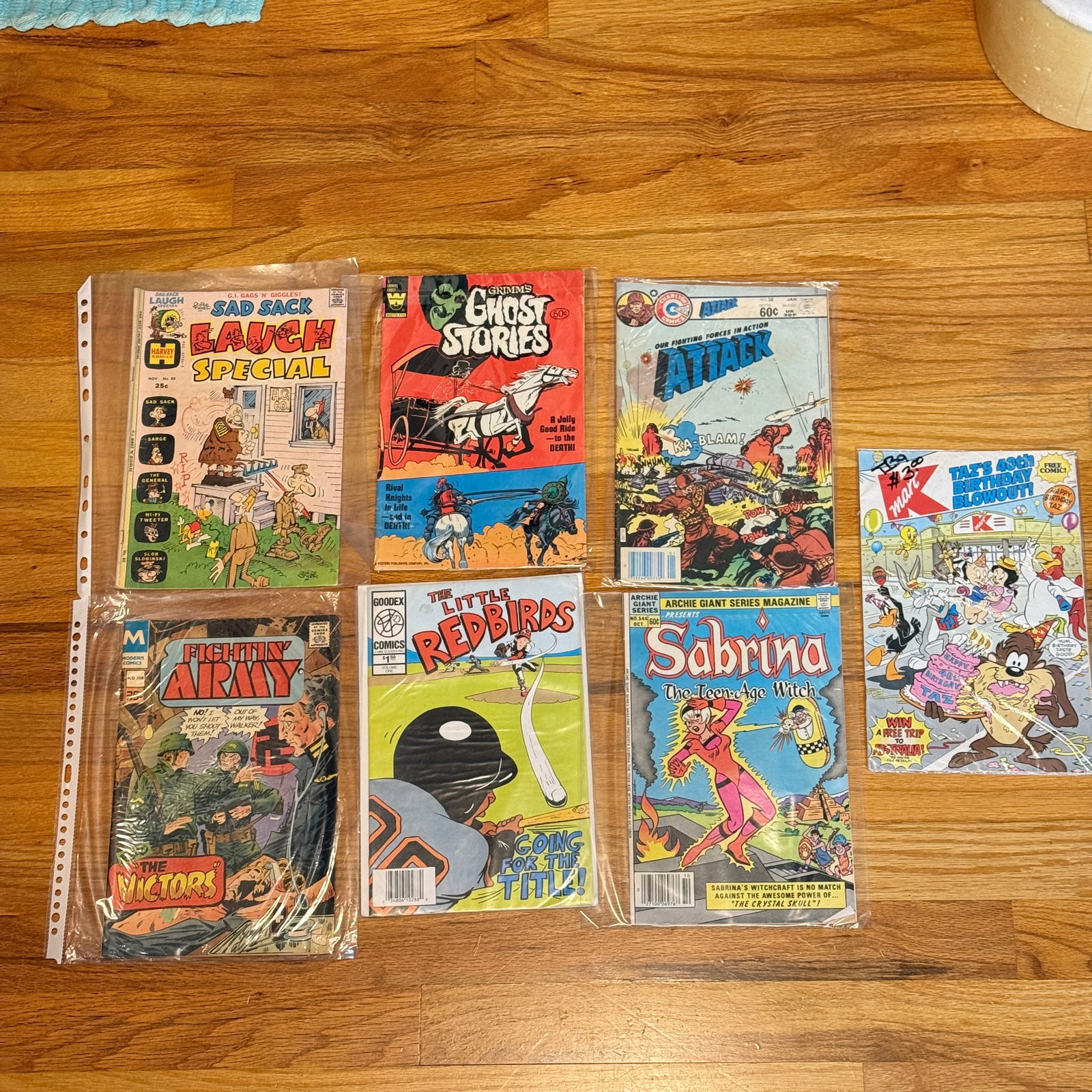 Mixed Vintage Comic Book Lot Harvey Archie Sad Sack: Group lot of seven vintage comic books including humor, horror, war, and cartoon titles from several publishers. Visible issues include Sad Sack Laugh Special (Harvey Comics), Grimms Ghost Stories (We