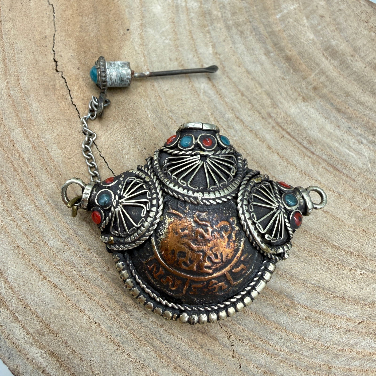 Tibetan Style Repousse Snuff Bottle Pendant: Decorative Tibetan style metal snuff bottle pendant featuring repoussé and applied wirework decoration. The body has a domed form with ornate silver-tone wire motifs and inset turquoise and coral col
