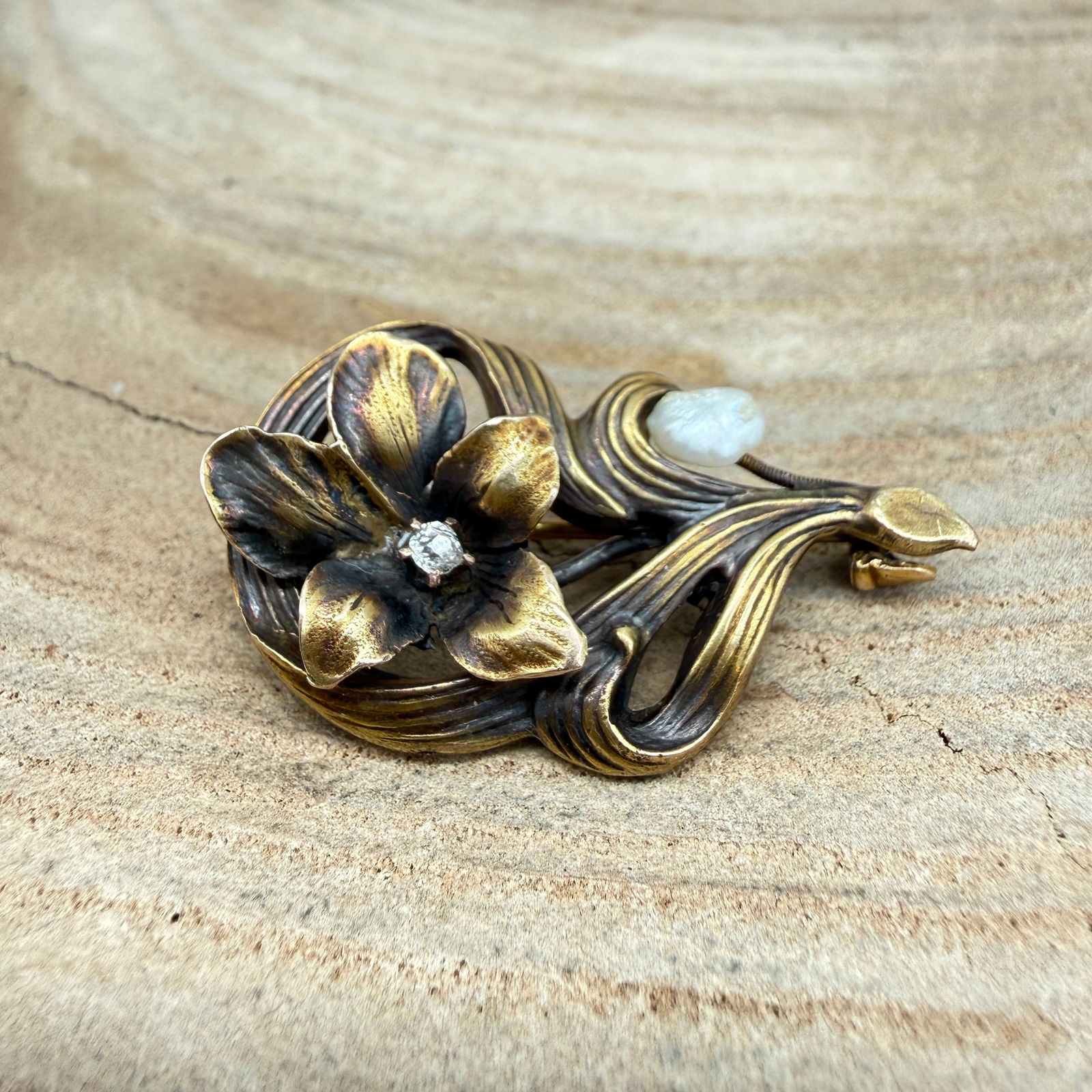 Antique Art Nouveau 10K Gold Diamond & Pearl Flower Brooch Pin: A beautifully detailed antique brooch, crafted in the romantic and naturalistic Art Nouveau style, circa 1900-1915. This piece depicts a stylized flower, likely an iris or dogwood, set in solid 10k go