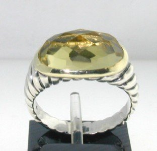 David Yurman Silver Lemon Citrine Ring: This is a Wonderful David Yurman Silver Lemon Citrine Ring! The total ring's weight is 5.3 grams. The size of the Lemon Citrine is 14 x 7 mm and enclosed by yellow gold "trimming". The size of the rin
