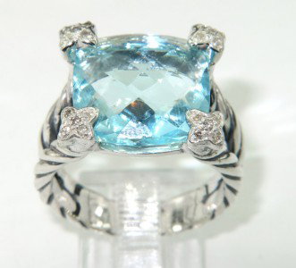 David Yurman Silver Blue Topaz & Diamond Ring. : David Yurman Silver Blue Topaz & Diamond Ring. The total ring's weight is 8.5 grams. The total weight of the diamond is 0.25 cts approximately, I color SI clarity. The size of the blue topaz is 13 x 1