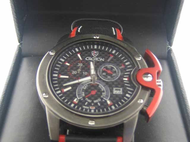 Croton Gents - CC311255BSRD Gents Watch: Aluminum and stainless steel case, Genuine black and red leather strap, Fixed bezel with screws, Black dial with red accents, 3 chronograph sub-dials, Date display, Sapphire crystal, Buckle clasp, 43 