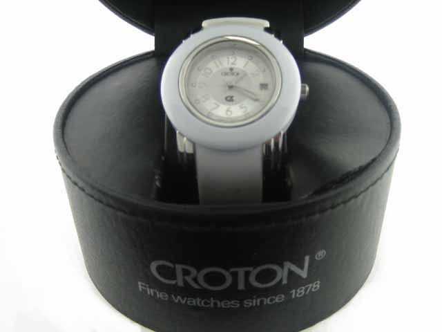 Womens Croton Rubber Date Watch: CROTON presents precision, quality, style and value in a womens watch sporting a smart rubberized adjustable band. White luminous hands and markers and date window are set in a large round white face