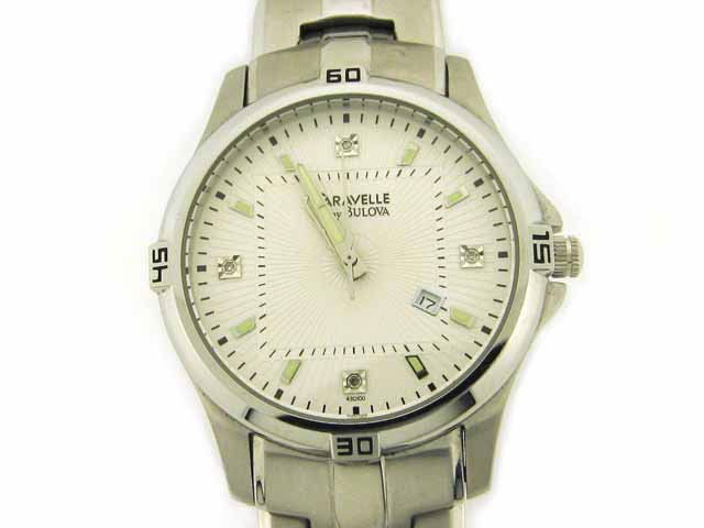 Caravelle Men"s watch (by Bulova): "• Dress watch • Quartz movement • Polished silver-tone hands and markers with luminous accents • Four diamond markers • Analog date display • Black indices • Polished stainless steel si