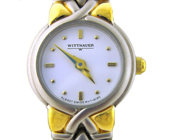 WITTNAUER Ladies Watch: This is a Wittnauer Ladies Watch. The watch has a two-toned band and the dial and the markers are gold plated. The watch case diameter is 3/4 inch by 1/4 inch thickness.