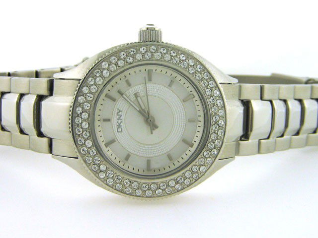 DKNY Womens Diamond NY4467 Watch: This is a DKNY Womens Diamond NY4467 Watch with the following features: Stainless Steel Case with Crystals on the Silver tone bezel and on the Push/Pull crown, Silver MOP Dial, Analog Display, Stainle