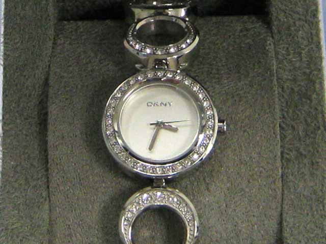 DKNY Women's Open Circle Bracelet Watch NY3650: This is a DKNY Women's Open Circle Bracelet Watch NY3650 with the following features: 24mm silver dial, silver band, analog display, quartz movement, stainless steel case, stainless steel band, water