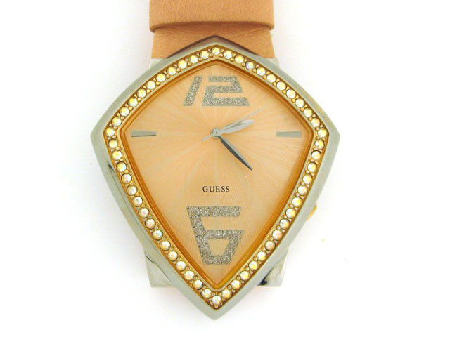 Guess Ladies Watch: This is a Guess Ladies Watch with the following features: Swarovski crystals on the bezel and at the 12:00 and 6:00 hour markers; Peach dial; Silver Hand; Leather Bracelet; and Japan Movement.