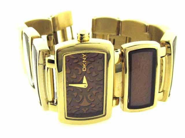 DKNY NY 4328 Watch: This is DKNY NY 4328 Watch. The watch is Gold Plated with Gold Tone Bracelet. The case diameter is 30 mm with 6 mm thickness. The watch has a brown colored dial with Quartz movement. The watch is wate