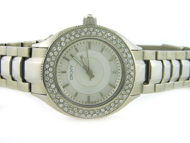 DKNY Womens Diamond NY4467 Watch : This is a DKNY Womens Diamond NY4467 Watch with the following features: Stainless Steel Case with Crystals on the Silver tone bezel and on the Push/Pull crown, Silver MOP Dial, Analog Display, Stainle