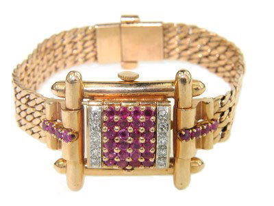 14K Rose Gold Ruby & Diamond Watch From 1950 : 14K Rose Gold Ruby & Diamond Watch From 1950,The total watch's weight is 43.1 grams.The measurements of watch head is 16 x 14 mm and 9 mm thick.The total weight of Ruby: 2 cts. approximatelThe total w