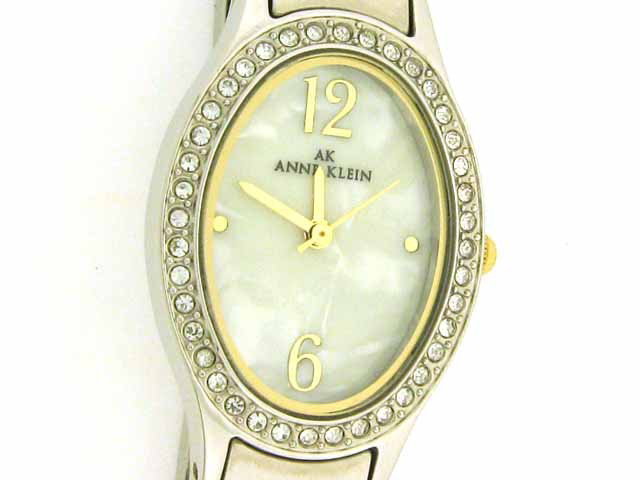 ANNE KLEIN TWO TONE OVAL SHAPED DRESS WATCH: ANNE KLEIN TWO TONE OVAL SHAPED DRESS WATCH with the following features: Japanese quartz movement, gold-tone Arabic numbers at twelve and six o'clock, gold-tone dot hour markers at three and nine o'cl