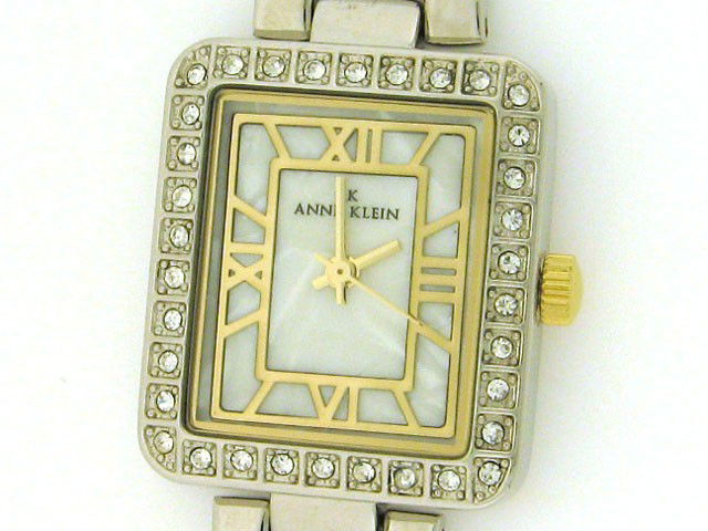 AK Anne Klein Women's Silver and Gold tone Watch w: Mineral crystal; Push/pull crown; Quartz movement; Case diameter: 21mm X 18 mm; Band:14mm