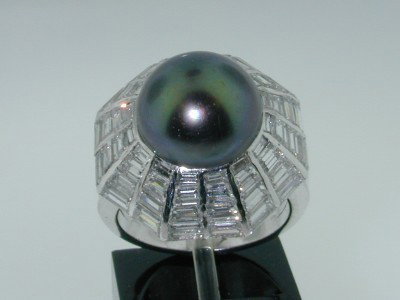 J.W Platinum Black Pearl Diamond Ring.: J.W Platinum South Sea Black Pearl Diamond Ring. The total ring's weight is 10.7 grams.The total weight of the Baguette Diamond is 2 ct. approximately. G color VVS clarity.The size of South Sea Black 