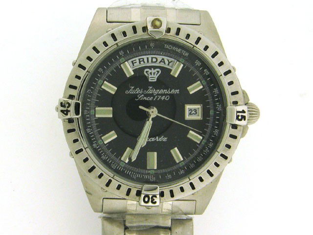 Jules Jurgensen Mens Sport Watch With Day/Date 7670W: This is a Jules Jurgensen Mens Sport Watch With Day/Date 7670W with the following features: Silver tone; Stainless steel case and bracelet with fold-over fastener; Black color dial; Crystal is made of