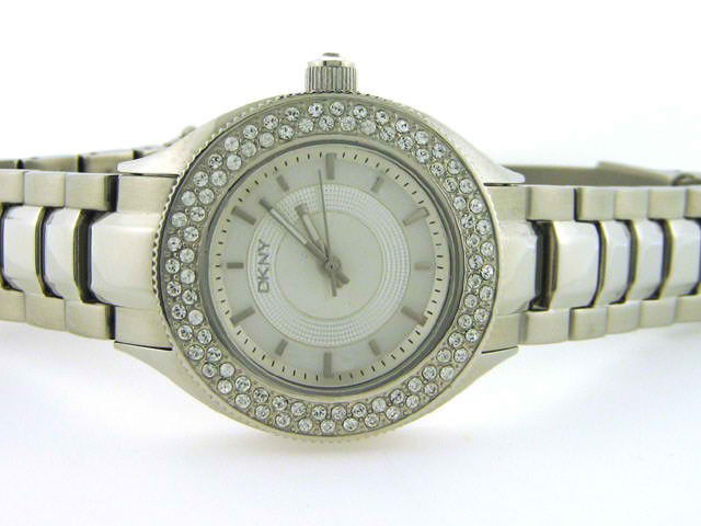 DKNY Womens Diamond NY4467 Watch: This is a DKNY Womens Diamond NY4467 Watch with the following features: Stainless Steel Case with Crystals on the Silver tone bezel and on the Push/Pull crown, Silver MOP Dial, Analog Display, Stainle