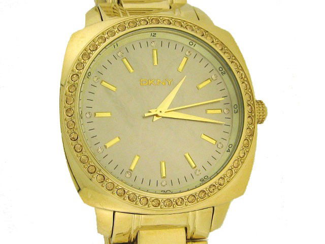 DKNY Round Gold Tone/Mother of Pearl Dress Watch: This is a DKNY Round Gold Tone/Mother of Pearl Dress Watch with the following features: Gold tone bracelet Fold-over clasp with push-button closure, stainless steel caseback, Three-hand analog quartz