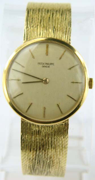 Patek Philippe 18K Yellow Gold Watch: Patek Philippe 18K Yellow Gold Watch.The weight of the watch is 58.5 grams.The measurement of the watch's head is 33 mm in diameter.7 mm in thickness.The length of the watch is 7".