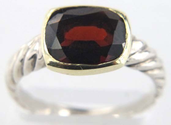 David Yurman 18K Gold/Silver Garnet Ring: David Yurman 18K Gold/Silver Garnet Ring.The total ring's weight is 3.9 grams.The size of the garnet is 10 x 8 mm.There is D.Y',925" stamp on it. The size of the ring is 6.75.The measurement of the su