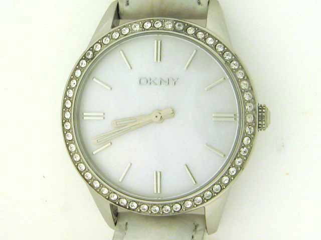 DKNY Women's Watch: Mother of pearl dial; crystal encrusted bezel, white leather band, water resistant to 50 meters, quartz movement, and stainless steel case back.
