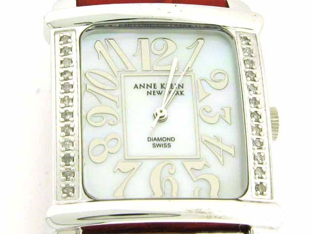 Anne Klein Watch Swiss Diamond Watch: Mother of Pearl dial; Leather strap; Base metal bezel; Water resistant; Swiss movement; Stainless back; diamond