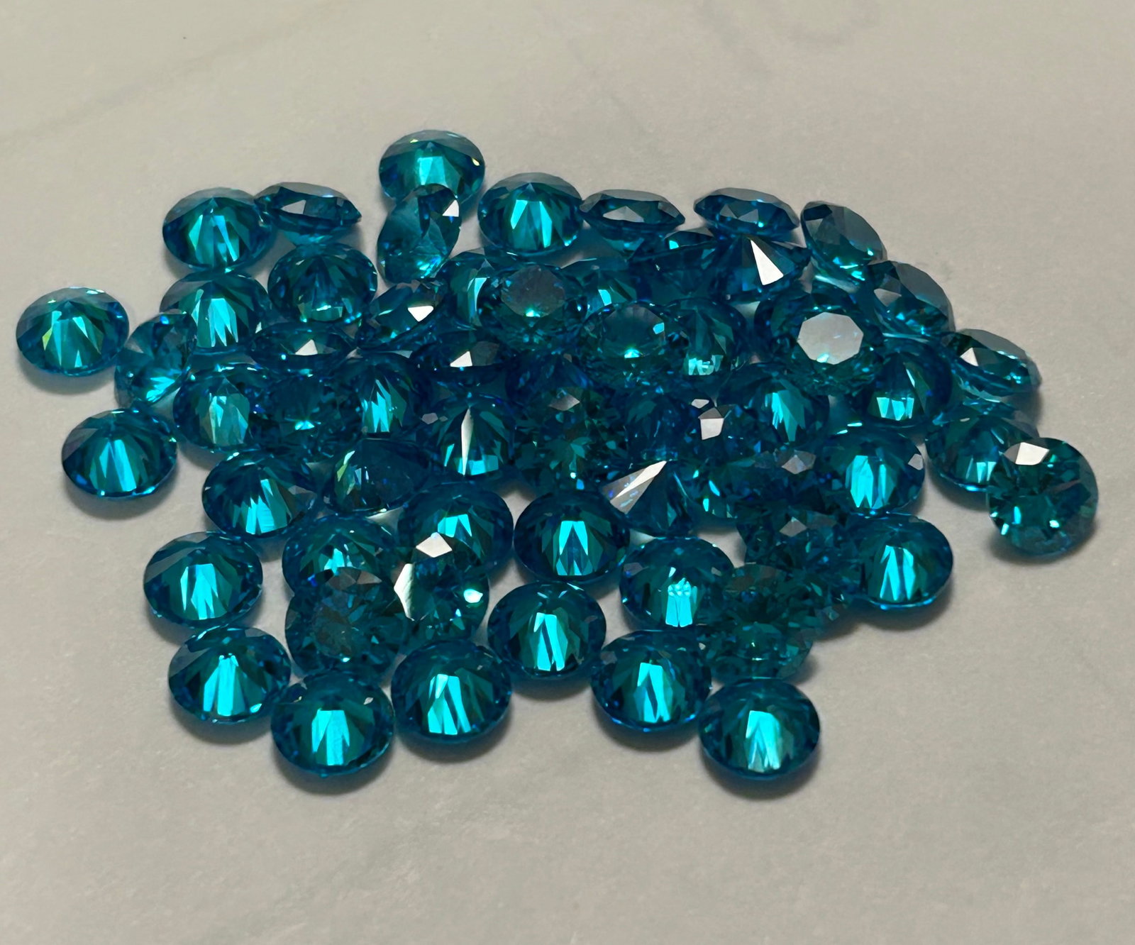 Natural Santa Maria Aquamarine 6mm 30 pcs Round Cut from Brazil: featuring the rare, deep greenish-blue 'Santa Maria' color, known for high clarity, 'eye-clean' quality, excellent polish, and significant value due to the original mine's scarcity, offering a vibrant