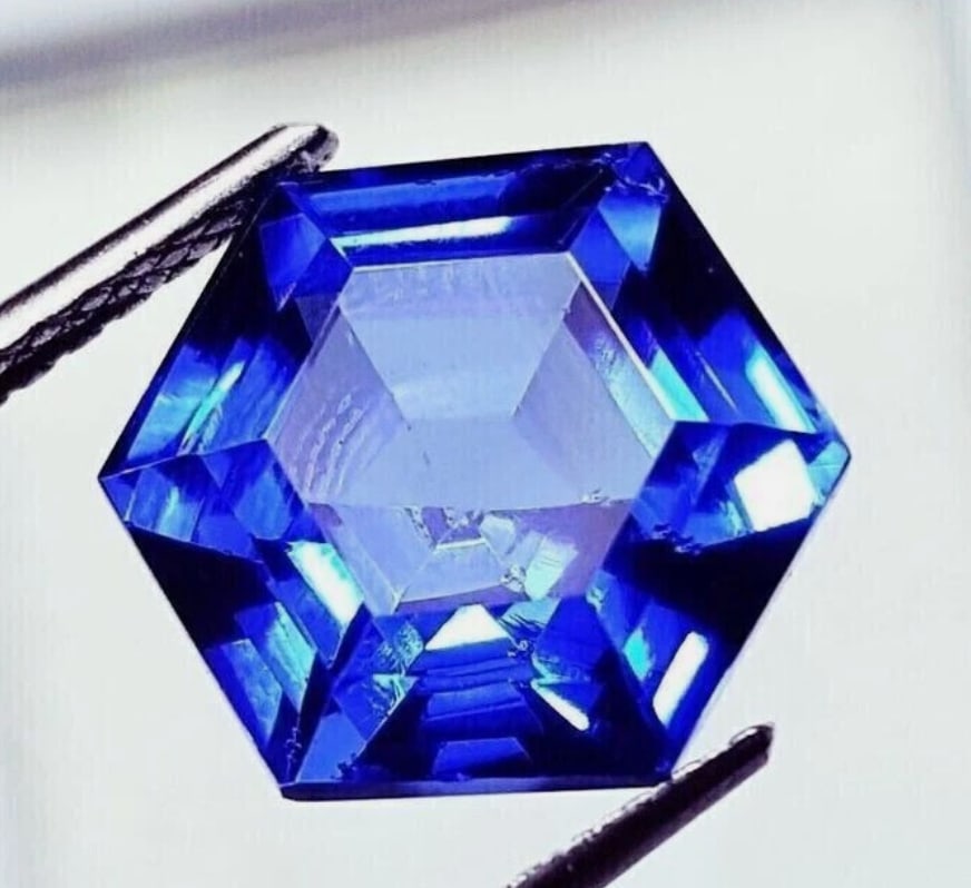 Flawless Blue Sapphire Fancy Hexagon Cut 10.70 Ct from Sri Lanka: a rare, high-quality gemstone prized for its deep, vibrant blue color, exceptional clarity (no visible inclusions), unique geometric cut, large size, and origin from famous Sri Lankan mines, making it